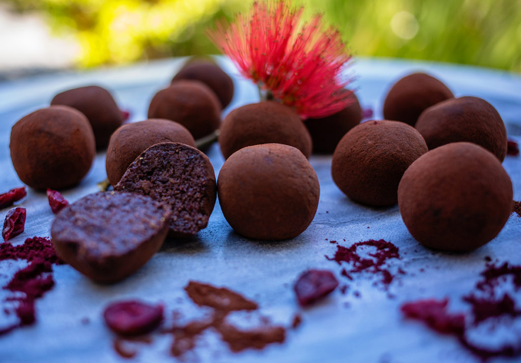Close up of paleo chocolate truffles with a bite taken out
