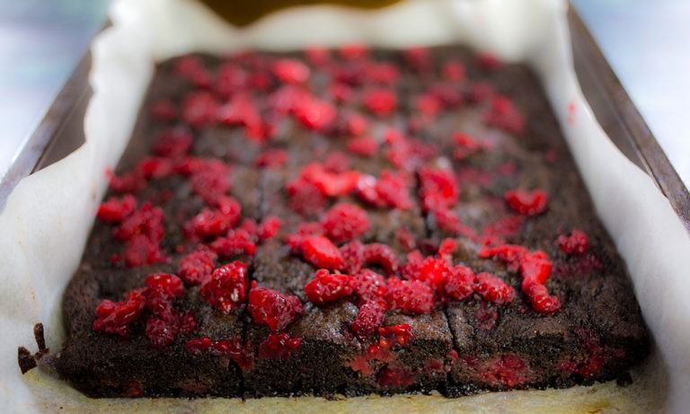Close up of chocolate raspberry brownies in baking tray