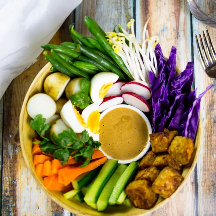 Gado Gado Indonesian Salad with white cloth and water to the side.