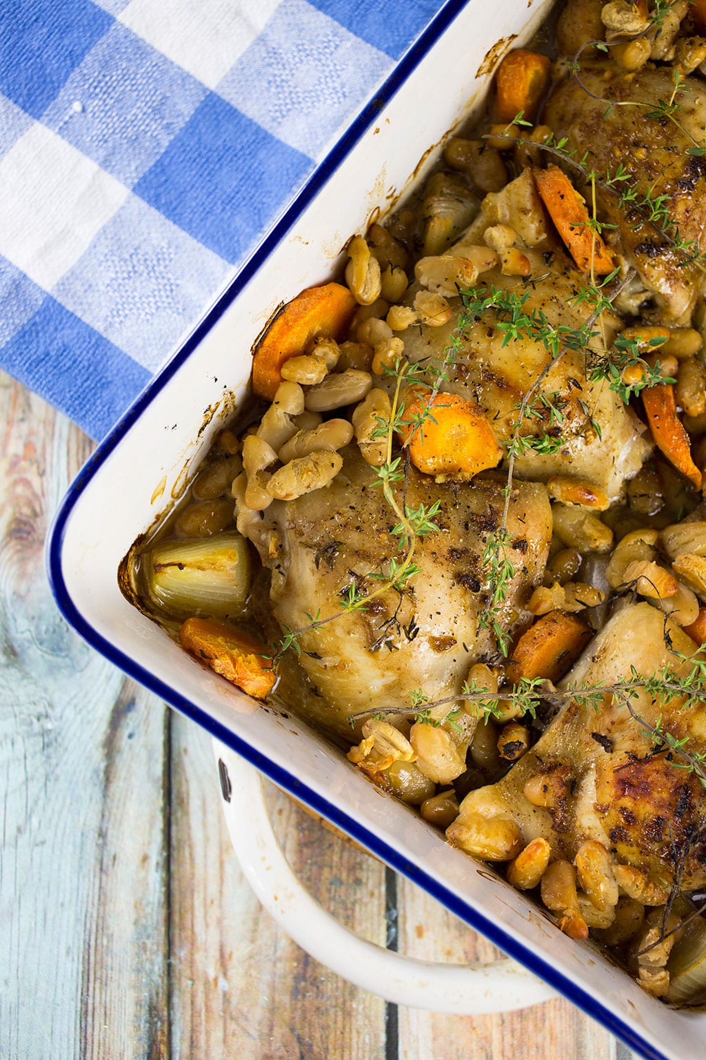 Close up of one pan chicken dinner with white beans and thyme