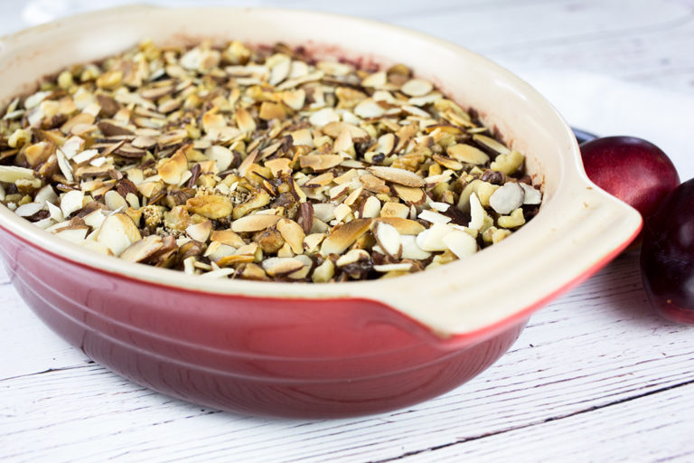 Apple and Plum Crumble with plumbs in background