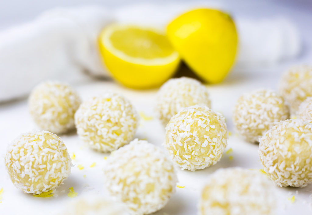 These creamy lemon coconut bliss balls make a tasty healthy snack - they are low carb, high protein, gluten, dairy and refined sugar free. With a delicious blend of zesty lemon and creamy coconut these paleo energy balls are an easy to make no bake snack! They are a low carb snack that you can grab n go! #paleo #paleodiet #cleaneating #lemon #energyballs #cleaneating #paleorecipes #lowcarb #lowcarbrecipes #energybites #glutenfreerecipes #dairyfreerecipes