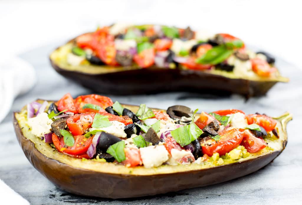 This healthy eggplant bruschetta recipe makes a healthy alternative to your classic bruschetta using delicious baked eggplant as the base. Topped with pesto, Mediterranean style veggies and dollops of cashew cheese this eggplant brucchetta recipe will become a new household favourite. Gluten Free, Paleo, Vegan and Whole 30 compliant.#eggplant #bruschetta #paleorecipes #appetizer #paleo #glutenfreerecipes #dairyfree #grainfree #mediterraneandiet