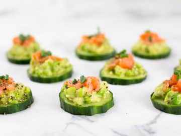 These smoked salmon cucumber bites with avocado pea smash make the perfect healthy appetizer. This easy appetizer requires no baking just keep in the fridge until ready to serve. Paleo, Whole30, low carb, dairy free and gluten free.#paleorecipes #salmon #appetizer #appetizerrecipeslow-carb #avocadoappetizerrecipes #avocado #salmonrecipes #lowcarbideas #whole30