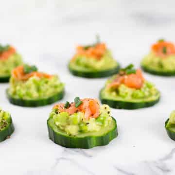 These smoked salmon cucumber bites with avocado pea smash make the perfect healthy appetizer. This easy appetizer requires no baking just keep in the fridge until ready to serve. Paleo, Whole30, low carb, dairy free and gluten free.#paleorecipes #salmon #appetizer #appetizerrecipeslow-carb #avocadoappetizerrecipes #avocado #salmonrecipes #lowcarbideas #whole30