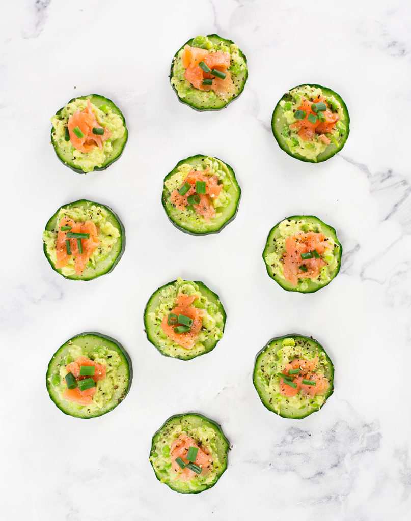 These smoked salmon cucumber bites with avocado pea smash make the perfect healthy appetizer. This easy appetizer requires no baking just keep in the fridge until ready to serve. Paleo, Whole30, low carb, dairy free and gluten free.#paleorecipes #salmon #appetizer #appetizerrecipeslow-carb #avocadoappetizerrecipes #avocado #salmonrecipes #lowcarbideas #whole30 