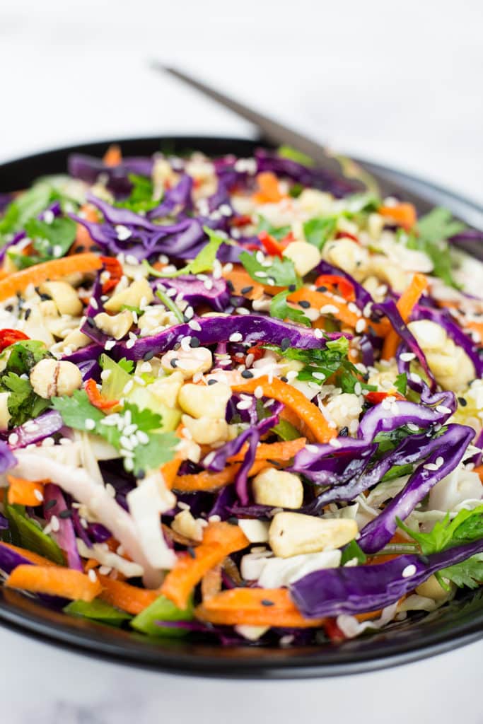 Close up of crunchy Asian Slaw with chopsticks in the background.