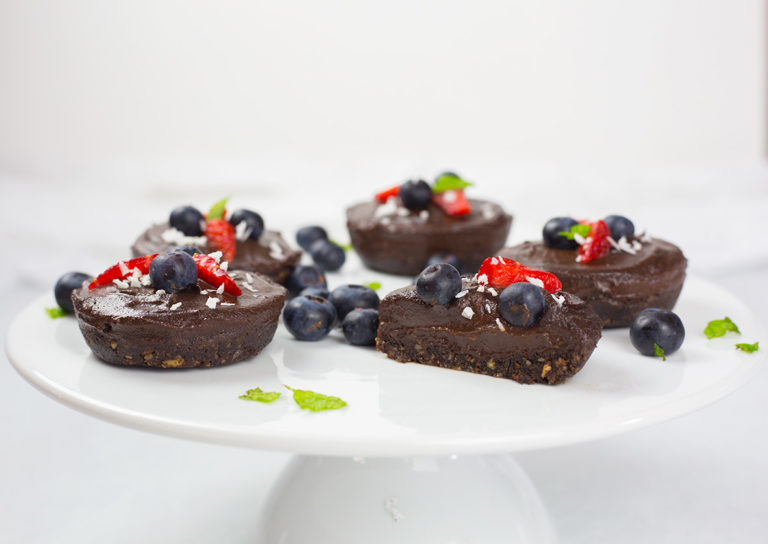 Dairy-free chocolate cheesecakes on white platter.