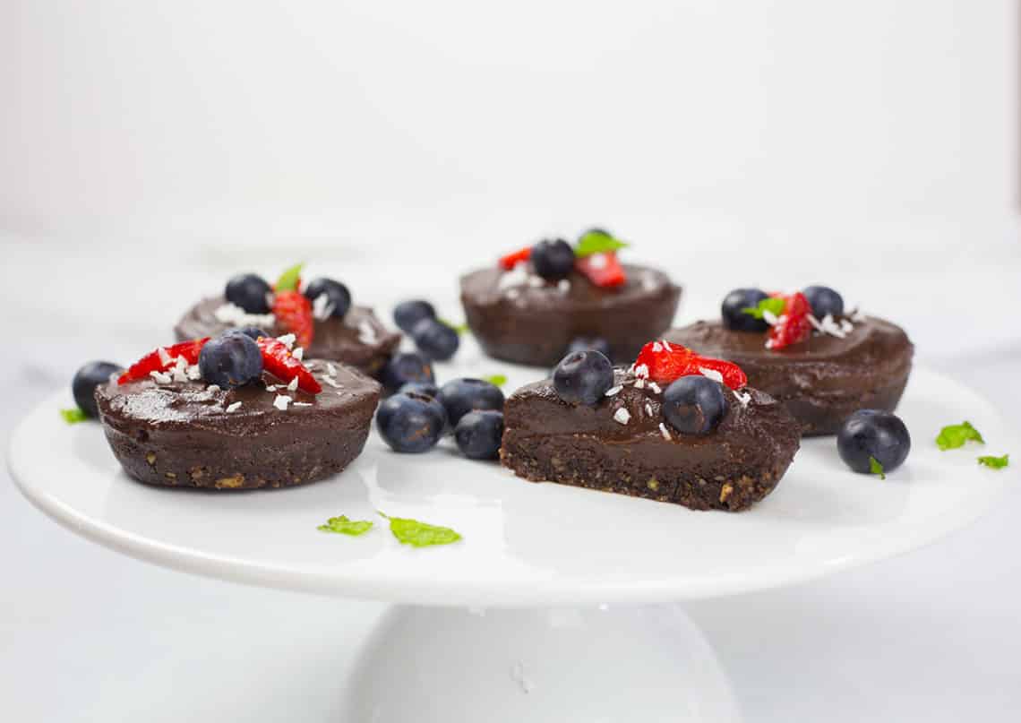 Dairy-free chocolate cheesecakes on white platter.