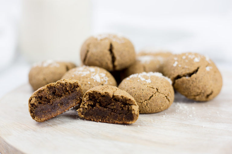 Ginger molasses cookies on board with one cute open.