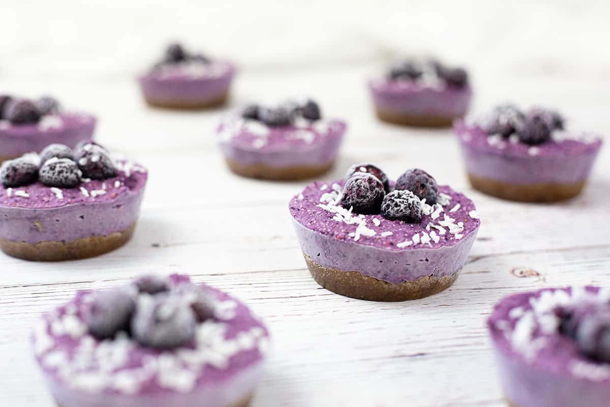 White chocolate blueberry cheesecakes on white background.