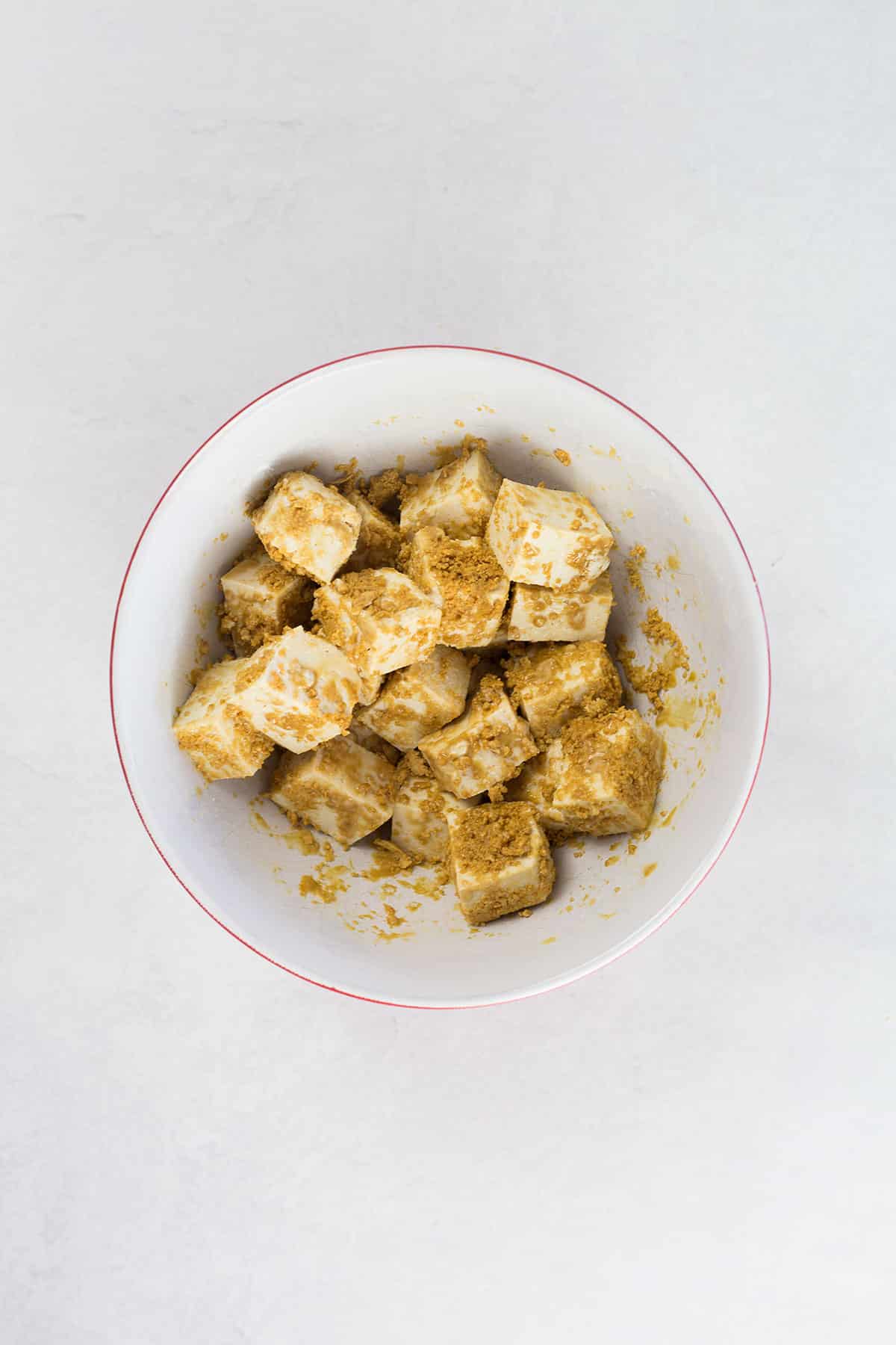 Tofu coated in golden cornstarch mixture.