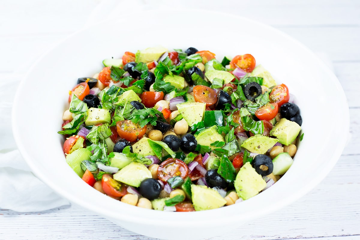 Chickpea Salad in white bowl with white background.