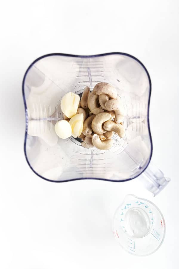 Garlic and cashews in food processor.