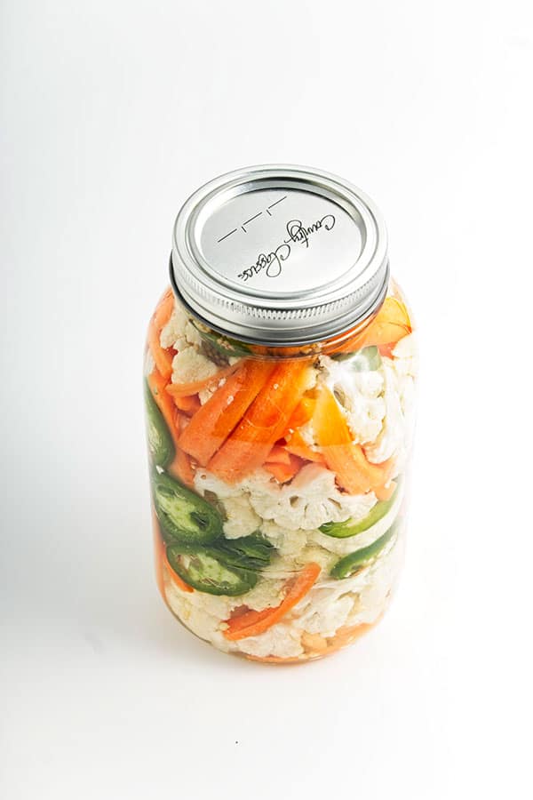 Pickled vegetables in jar with lid on.