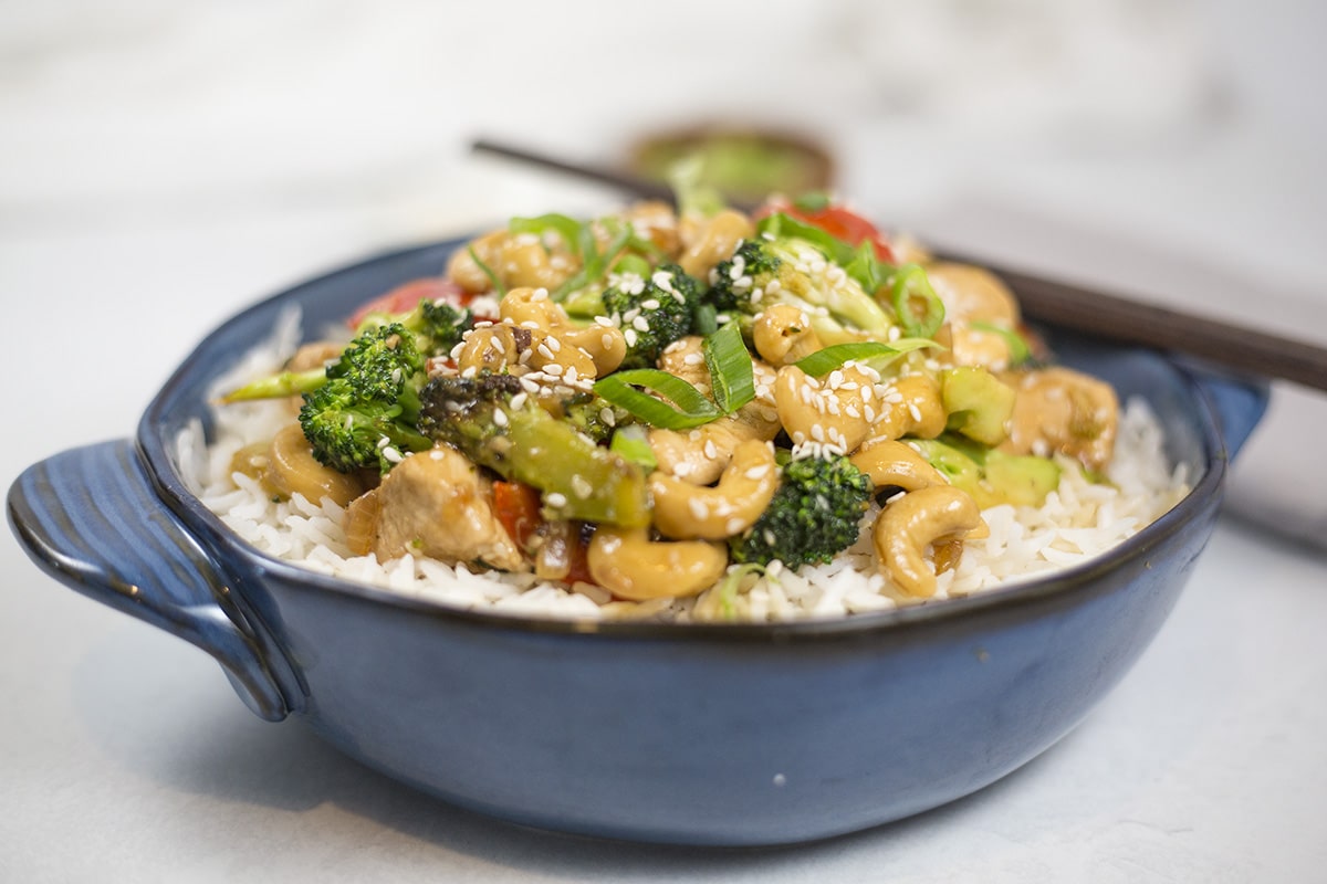 Chicken Broccoli Cashew Stir-Fry in blue dish with chop sticks.